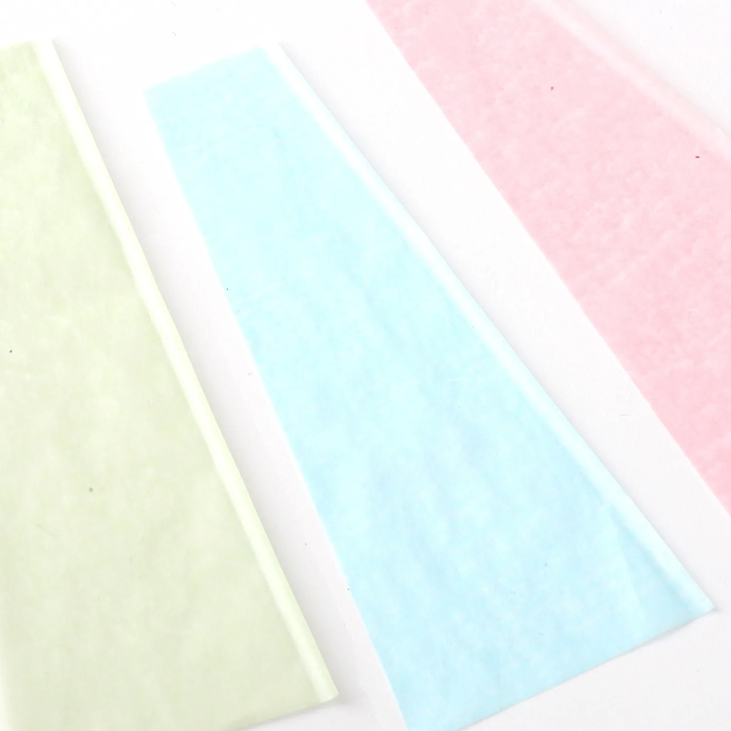 Pastel colored paper material sheets close-up