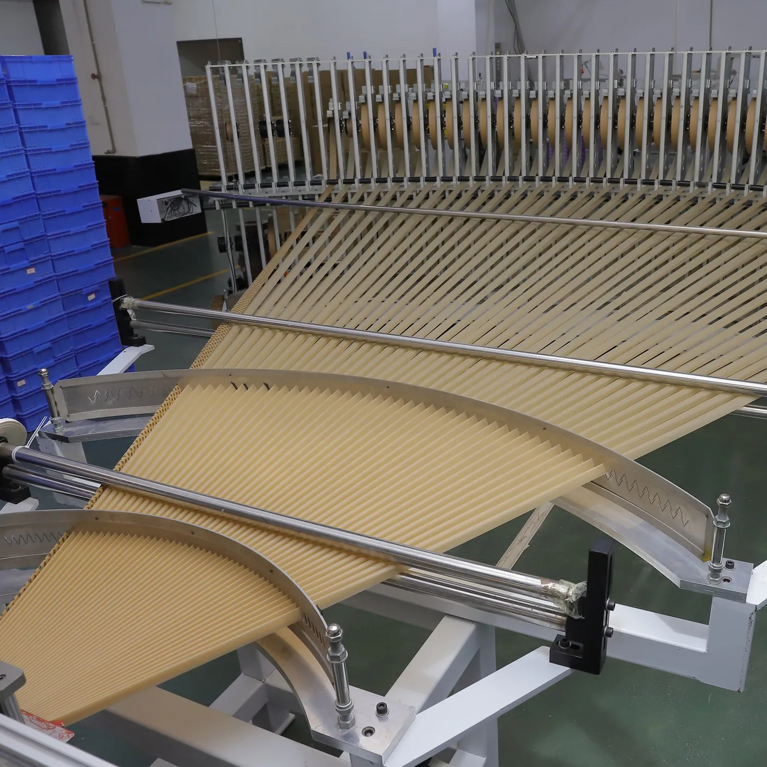 Rows of pre-rolled cones moving through Ace Rolling production equipment