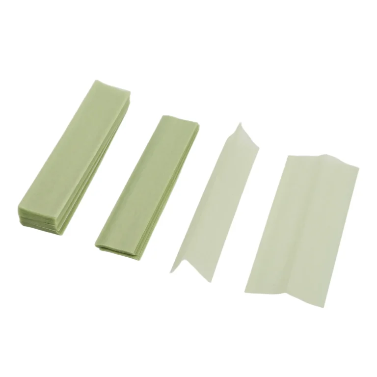Natural thin rolling paper sheets and stacks on white background