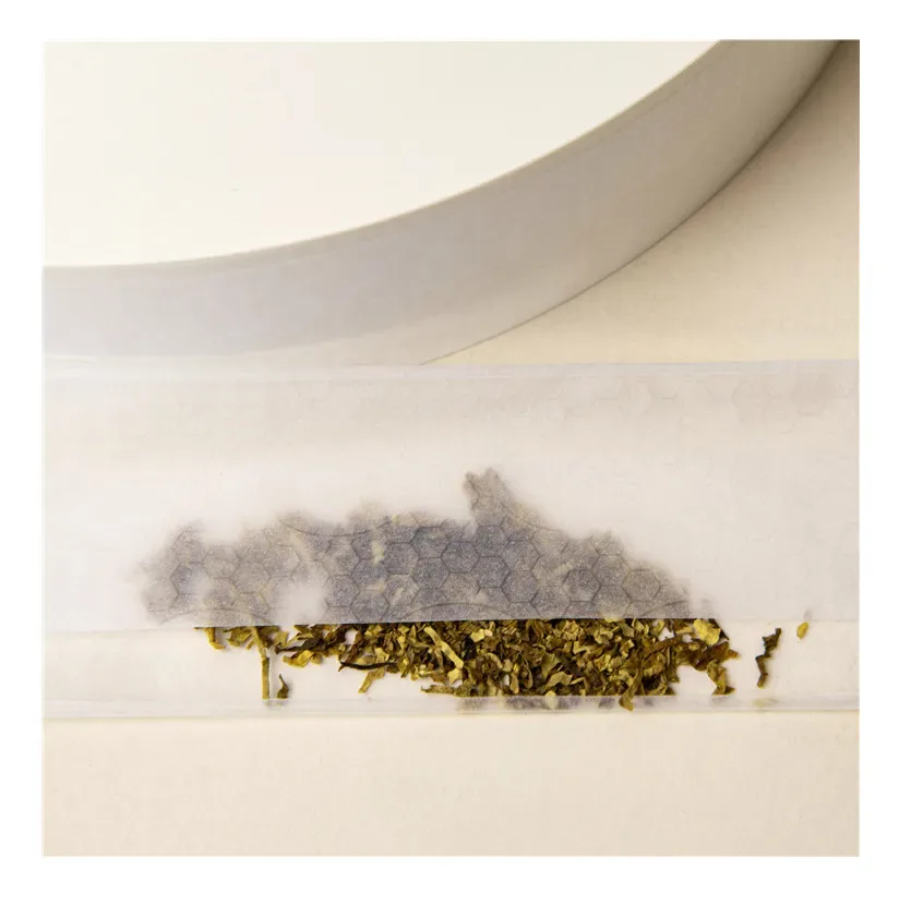 Ultra-thin watermarked rolling paper sheet showing edge adhesion surface