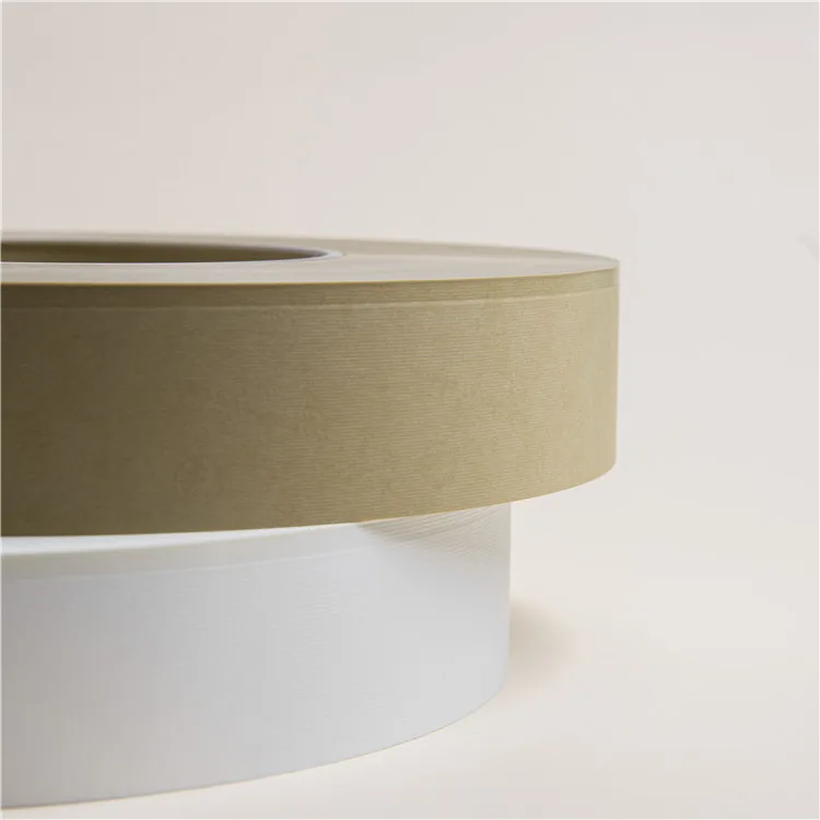 Stacked unbleached brown and white industrial paper bobbins