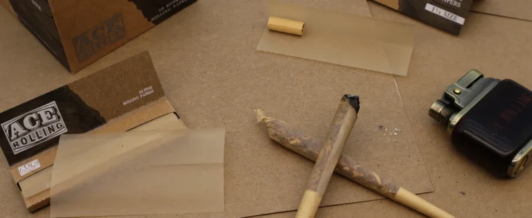 Ace Rolling fine rolling papers with open booklet, tips, and finished rolls
