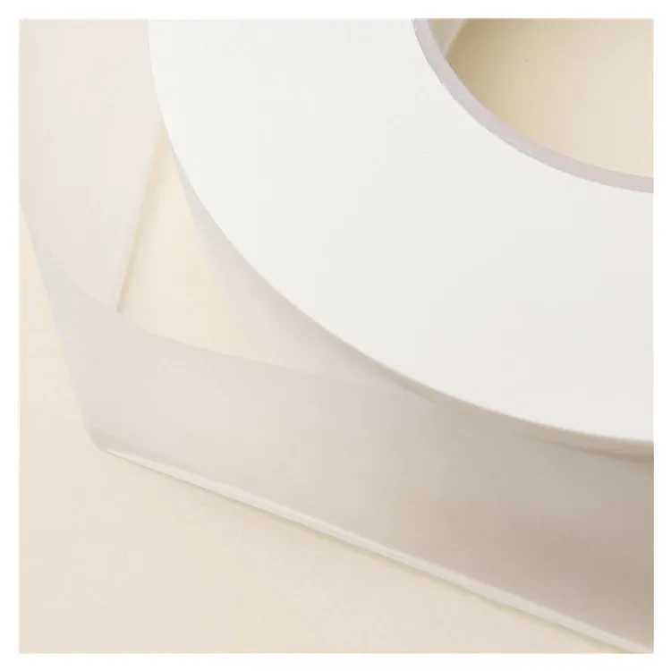 Stacked natural and white paper bobbins after width converting