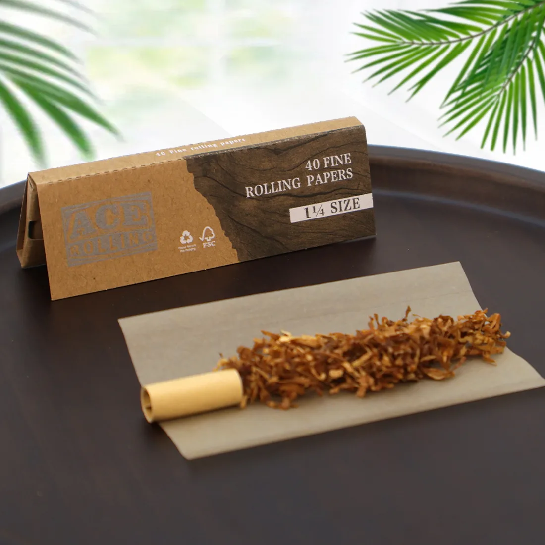 Ace fine 1 1/4 rolling paper booklet with leaf and tip staged for retail